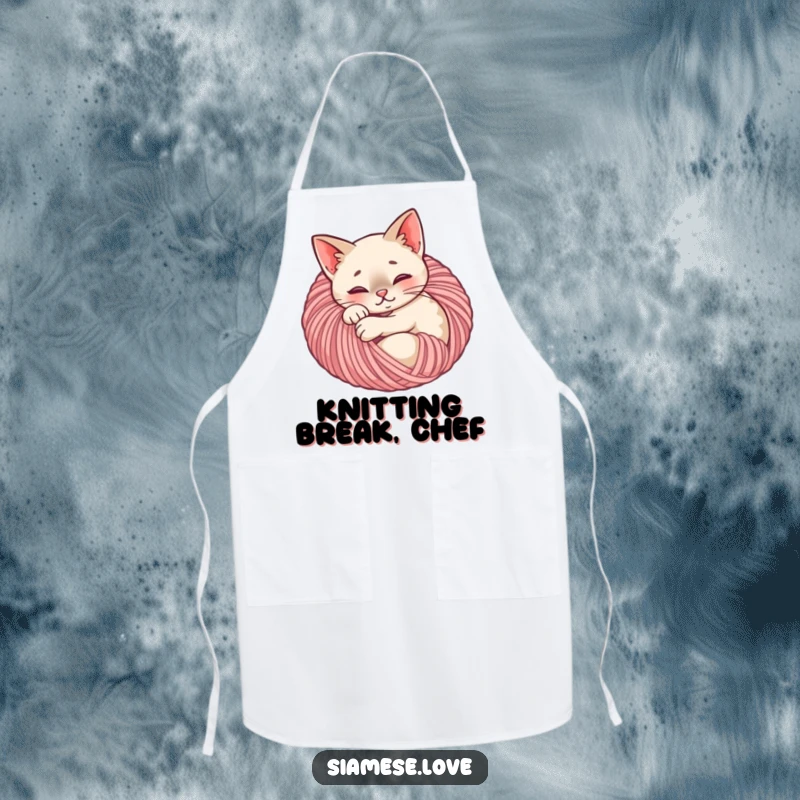Funny Siamese cat apron showing a content feline curled up in a ball of yarn, a humorous and practical kitchen accessory.