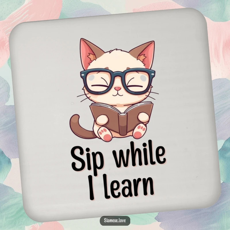 Funny Siamese cat drink coaster depicting a cat in glasses reading a book upside down, a humorous accessory for tables.
