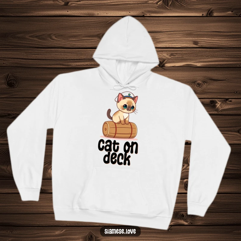 Funny kawaii Siamese cat hoodie design, featuring a sailor cat balancing precariously on a rolling barrel.