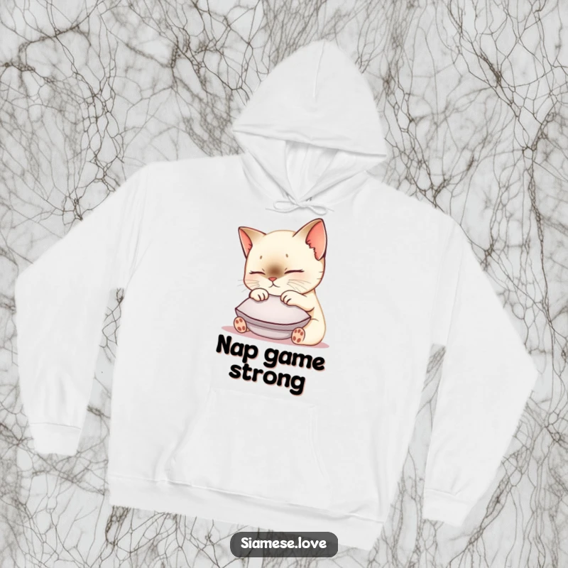 Funny Siamese cat hoodie depicting a cute kawaii kitty nuzzling a small cushion, exuding warmth, comfort, and a contented purr.