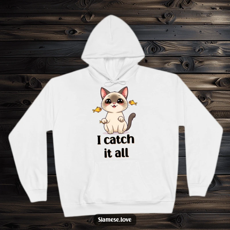 Funny Hoodie: A cheerful Siamese cat juggling three tiny fish, showcasing its impressive and humorous skills.