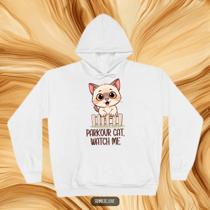 Funny Siamese cat hoodie showing a startled feline jumping over a fence, designed for cozy comfort and humorous appreciation.