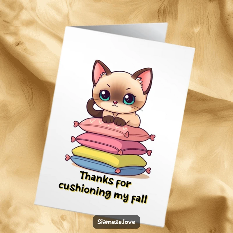 Funny Free Printable Thank You Card: A Siamese cat delicately perches on colorful cushions, conveying thanks with elegance.