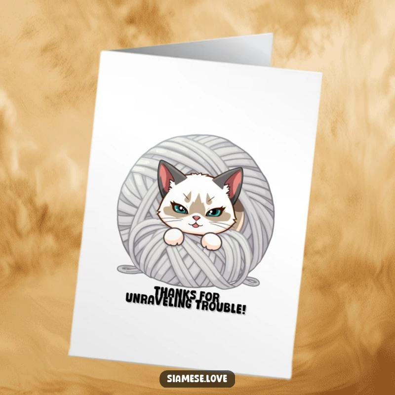 Funny Free Printable Thank You Card: A Siamese cat with a smirk hiding behind yarn, expressing thanks.