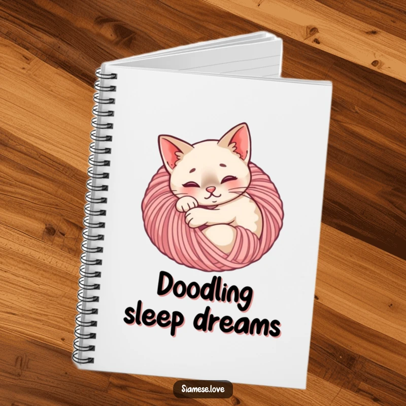 Funny Siamese cat notebook cover showing a content feline curled up in a ball of yarn, ideal for journaling with coziness.