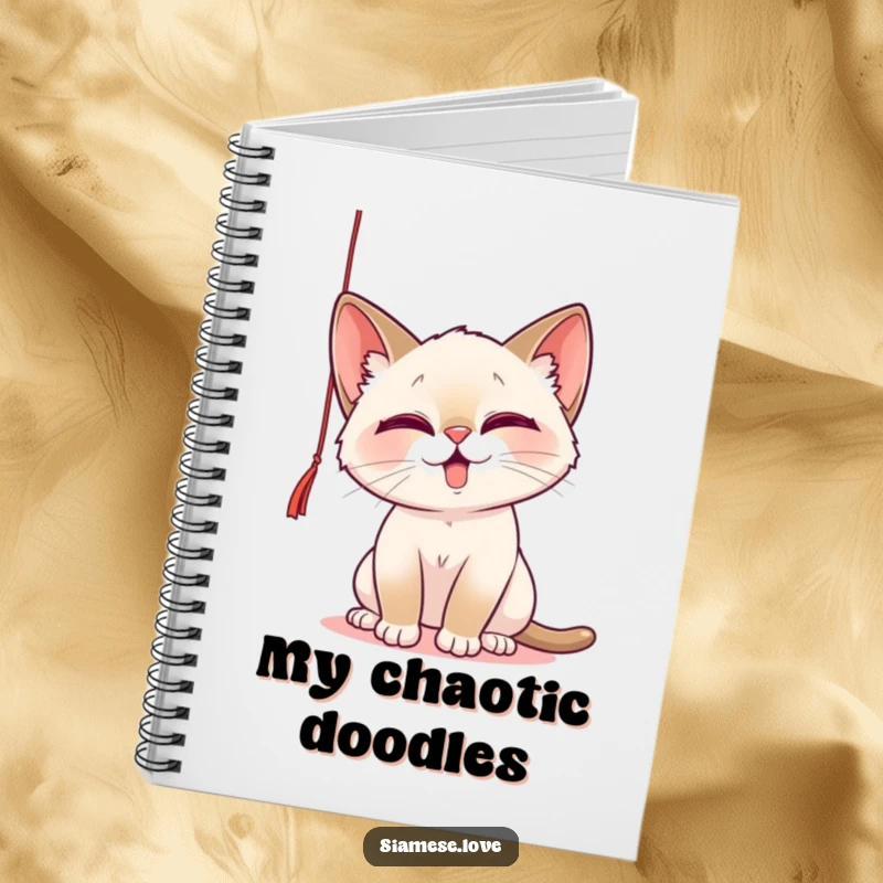 Funny Notebook with a playful Siamese cat batting at a dangling string, ideal for jotting down notes with feline humor.