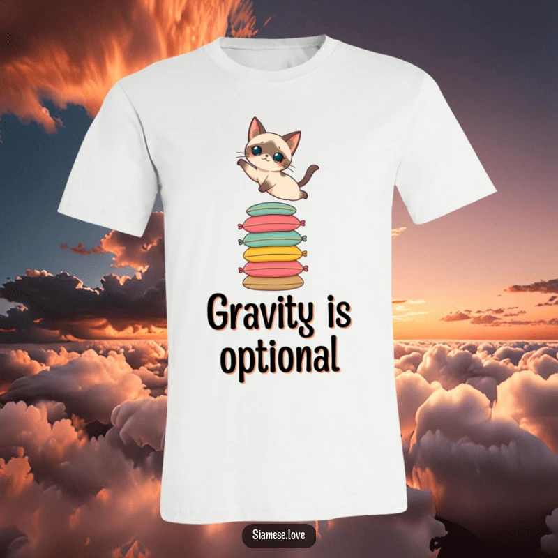 Funny t-shirt featuring a Siamese cat performing an elegant leap onto a towering stack of colorful cushions. Whimsical and stylish.